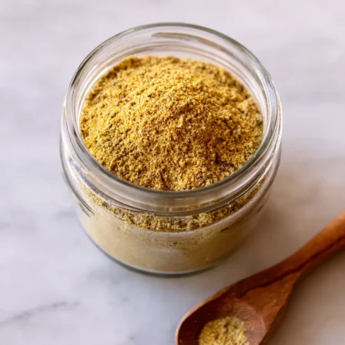 Beef Bouillon Powder 6 Homemade beef bouillon powder in glass jar with fresh ingredients and measuring spoon